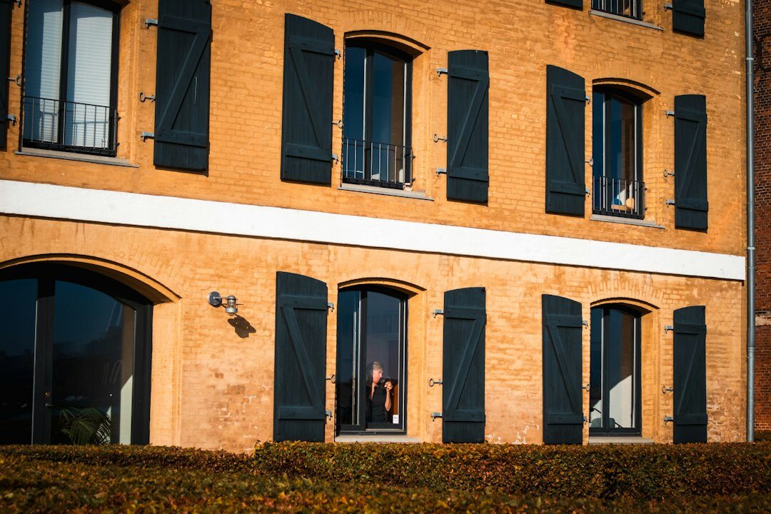Elderly Danish man sitting by a window telling his personal story